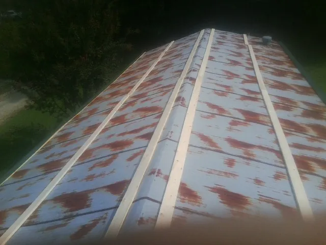 Rusted metal roof panels with new wood purlins before replacement — Storm Damage Roof Repair in Tennessee by Roofing Brothers