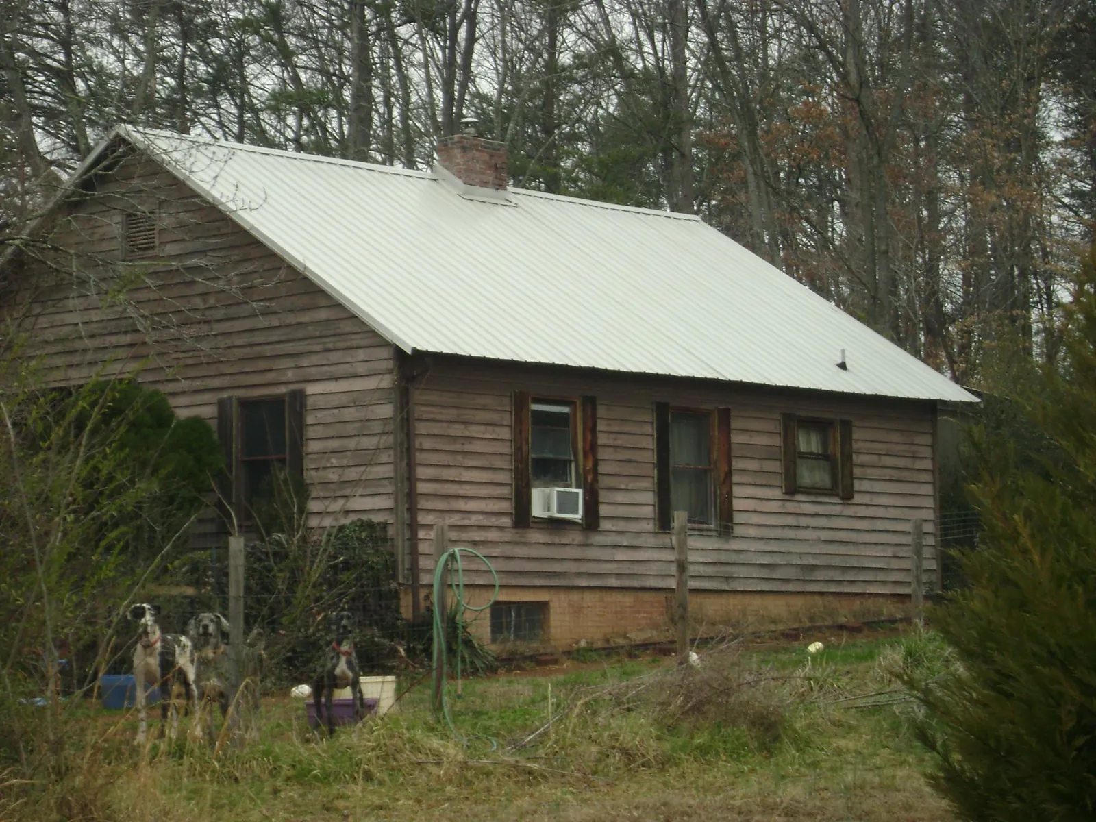 White metal roof on an old wood sided farmhouse, from a Metal Roof Installation job in Tennessee